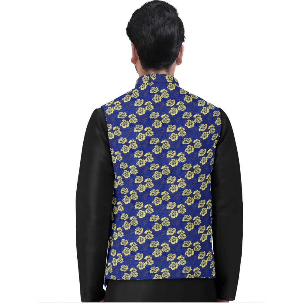 Man wearing a blue floral patterned vest over a black shirt on a white background