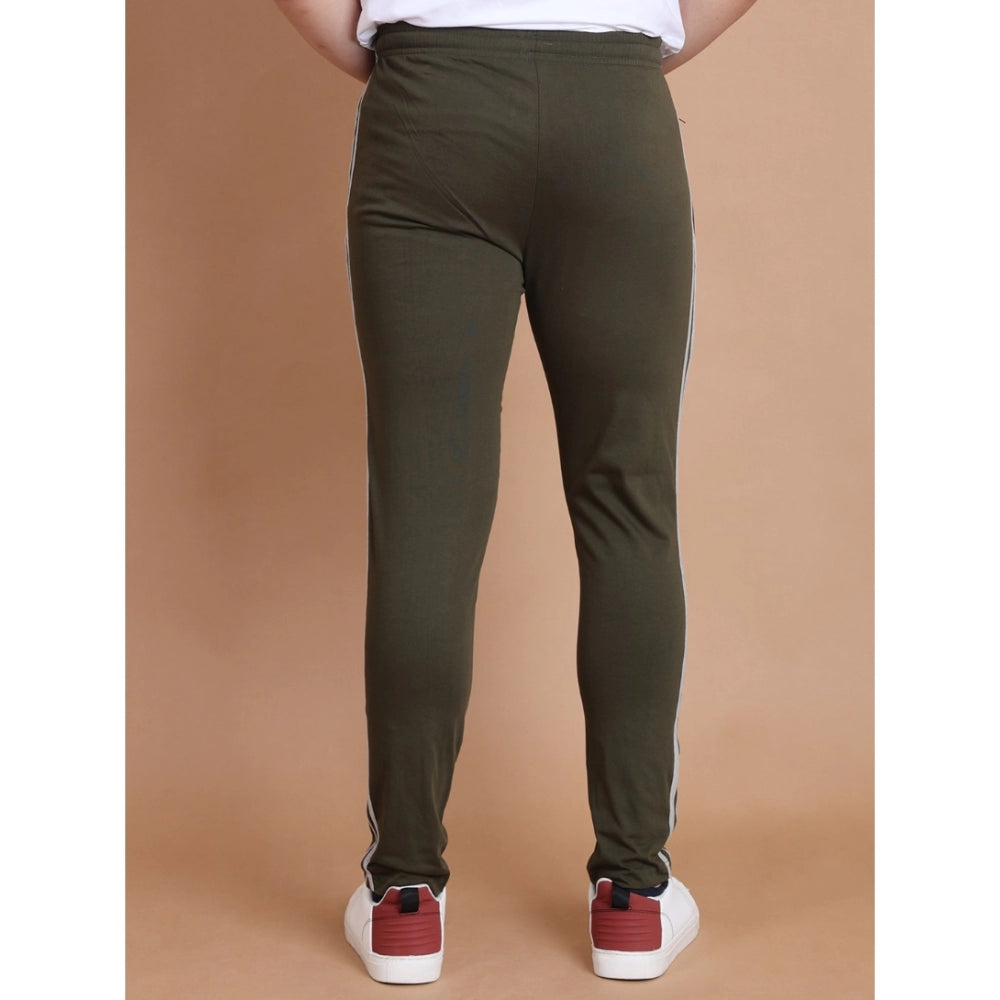 Person wearing olive green pants on a brown background