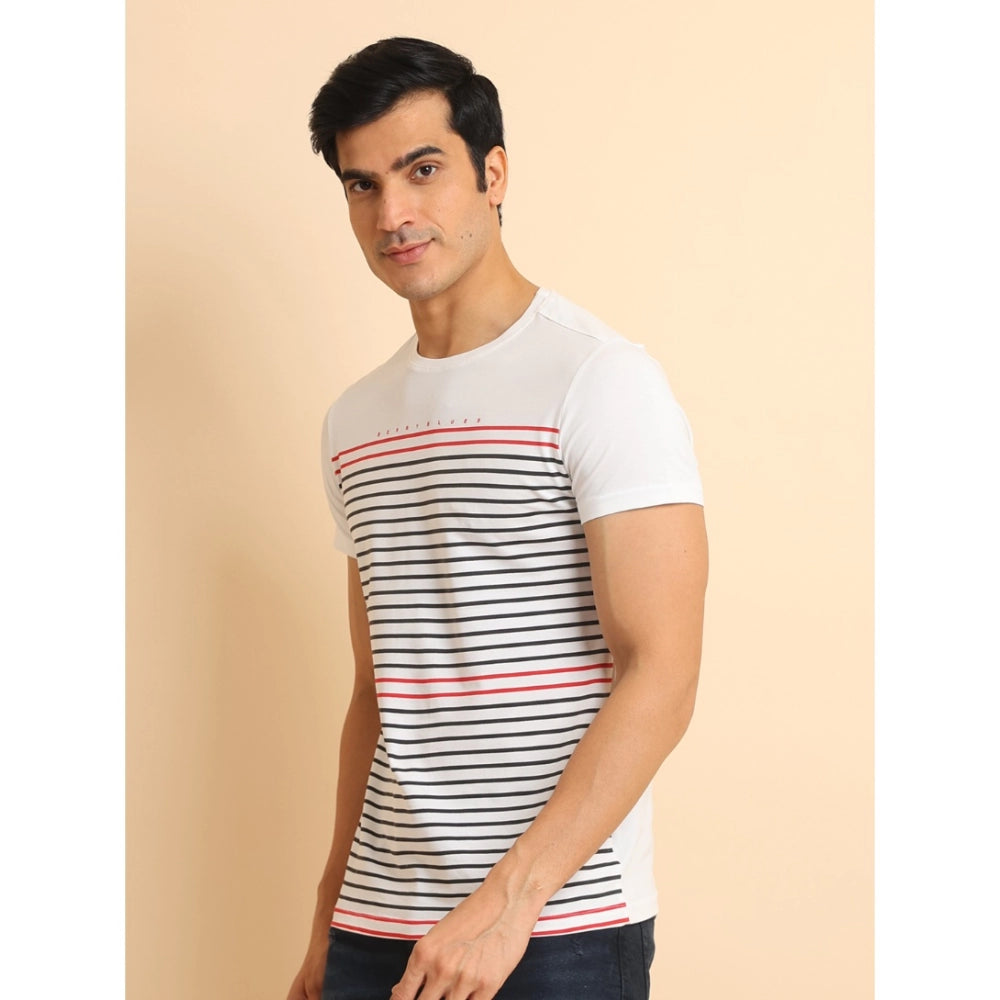 Man wearing a white t-shirt with black and red stripes on a beige background