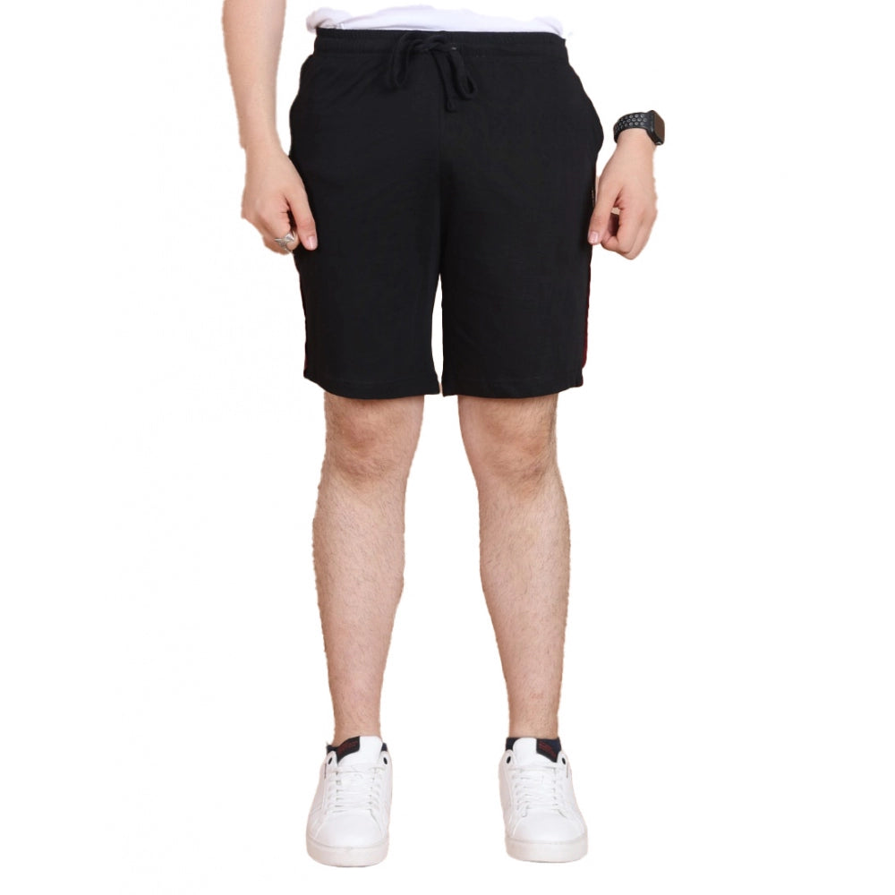 Person wearing black shorts on a white background