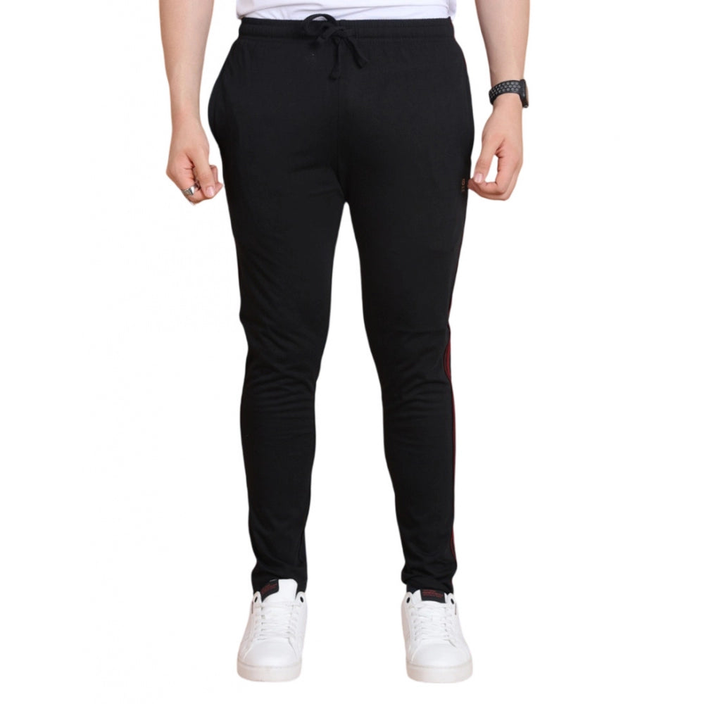 Person wearing black jogger pants on a white background