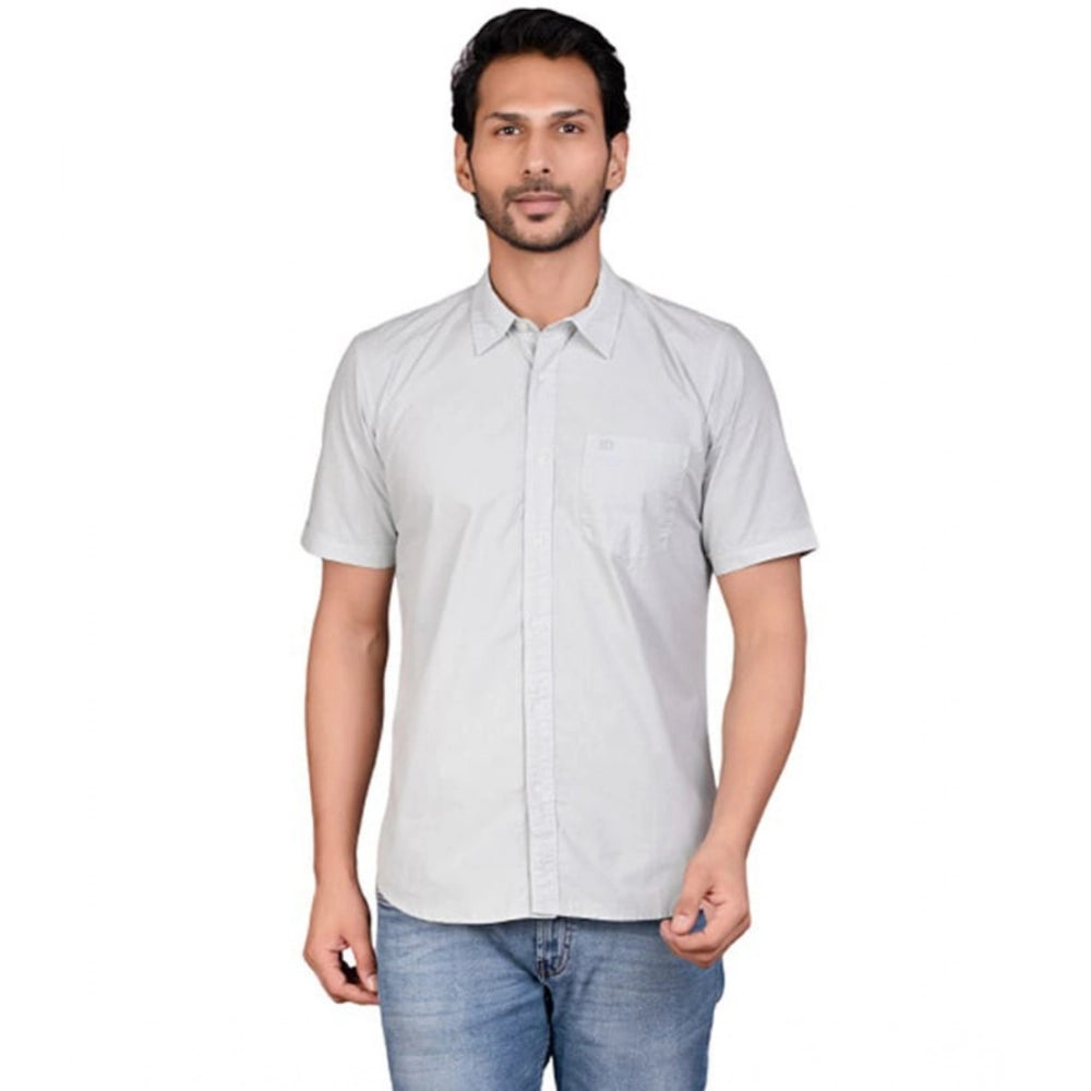 Man wearing a light gray short-sleeve shirt on a white background