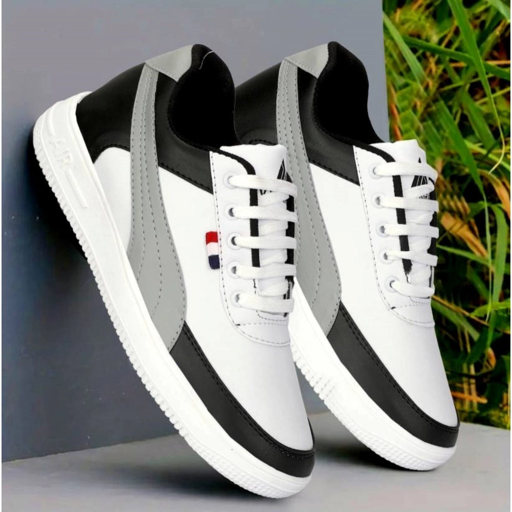 White and black sneakers with a gray background