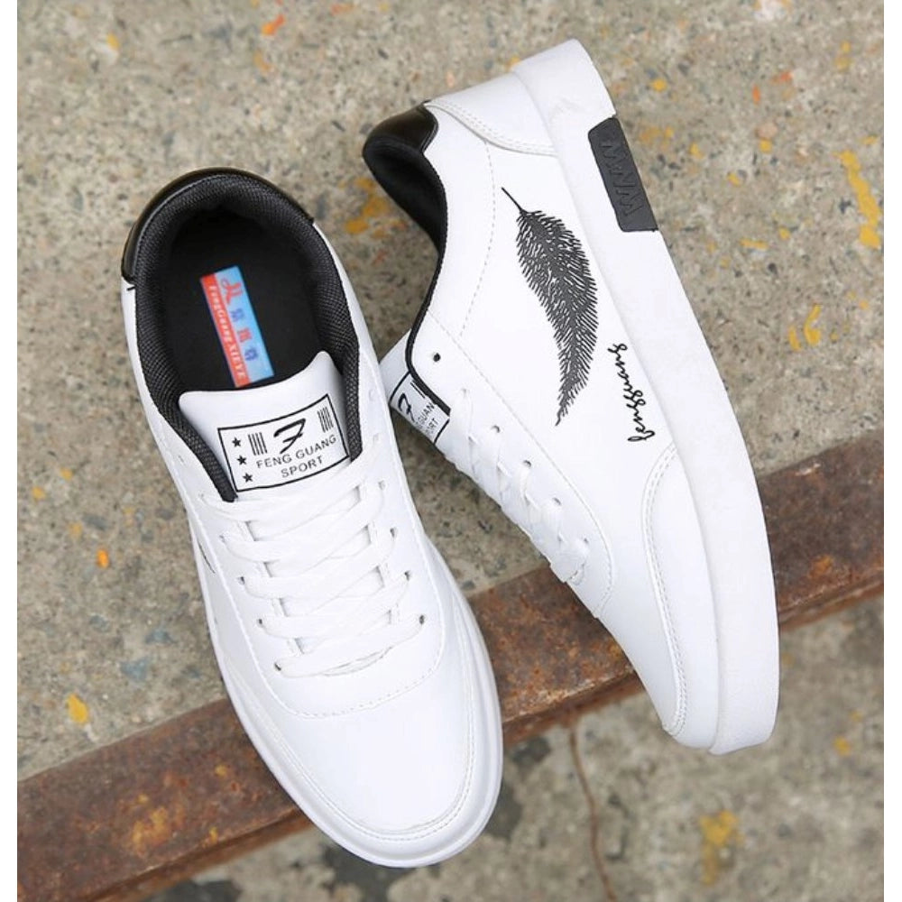 White sneakers with black feather design and branding on a concrete surface