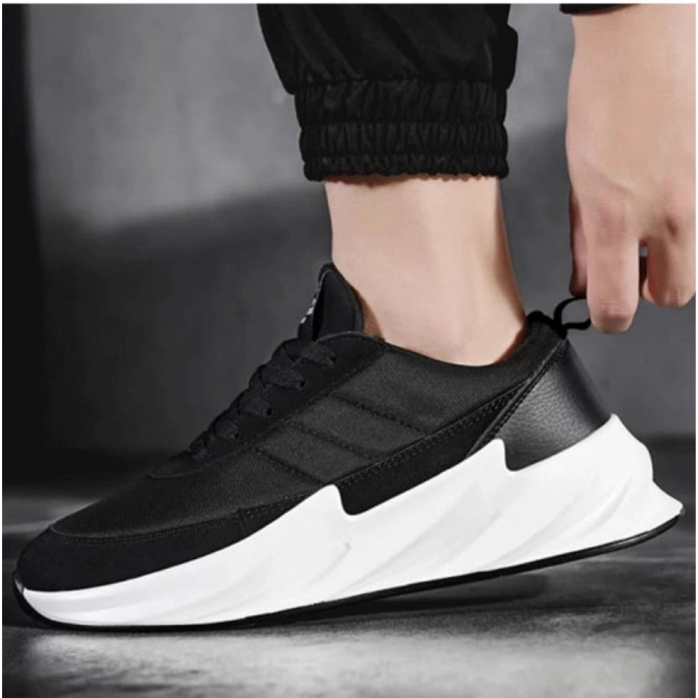 Black and white sneaker being worn on a dark background