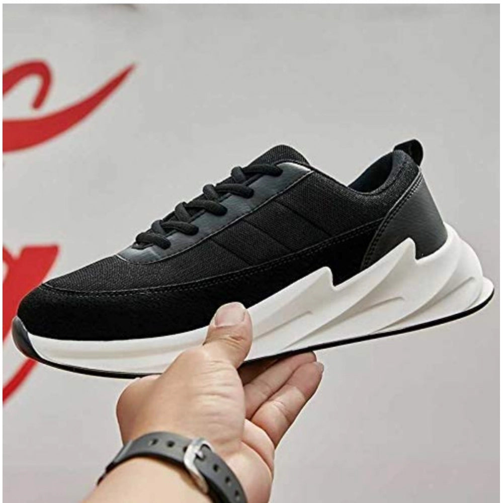 Black and white sneaker held by a hand with a blurred background